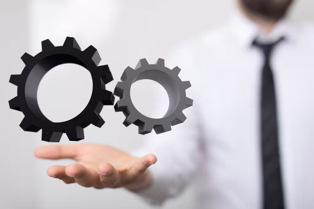 Man holding floating gears symbolically