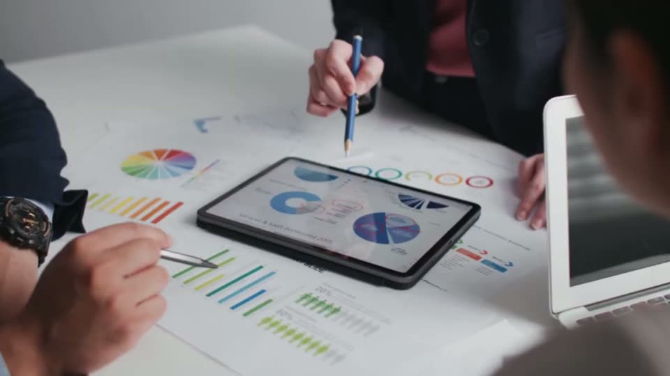 Two people reviewing charts on a tablet