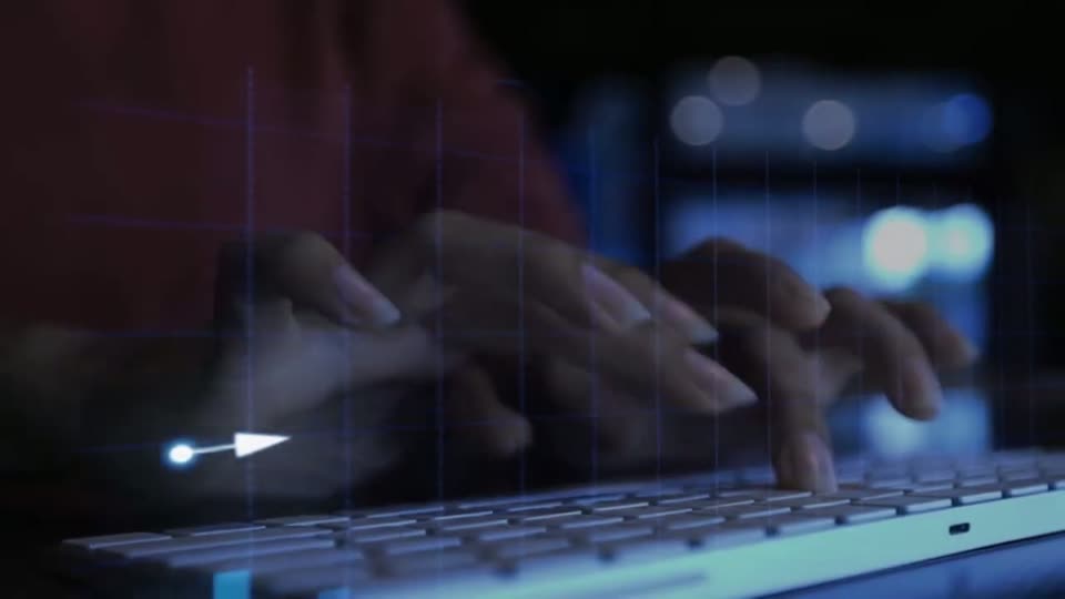 Hands at a keyboard with a rising chart of light